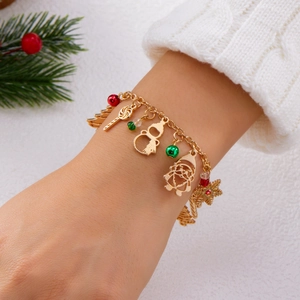 Detail of a festive Christmas charm bracelet with Santa, snowman and snowflake pendants
