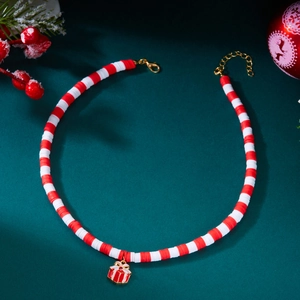 Detail shot of a double-layered Christmas necklace with a red gift box pendant and beads