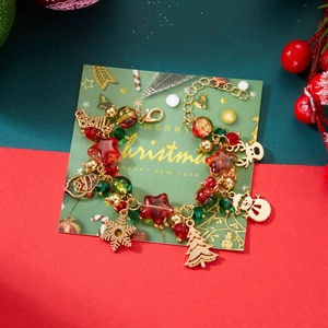 Christmas themed charm bracelet with gold metal icons on festive red and green background