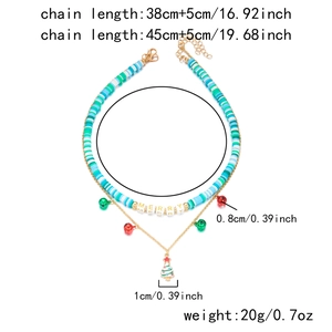 Detailed view of Christmas layered necklace with Merry beads, bells and tree pendants
