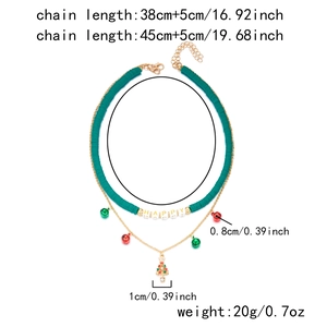 Detailed view of festive double-layer necklace with Christmas tree and bell charms