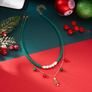 Detail of Christmas double-layer necklace with green beads and festive charms