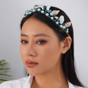 Detail of bohemian mermaid headband with seashells, starfish and pearls on a model