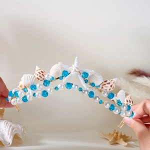 Close-up of mermaid bridal headband with seashells, starfish and blue crystal beads