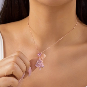 Detail of Christmas tree pendant with pink crystals and star charm on rose gold chain