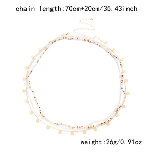Detail of multi-layer beaded waist chain with golden sequins and lobster clasp closure