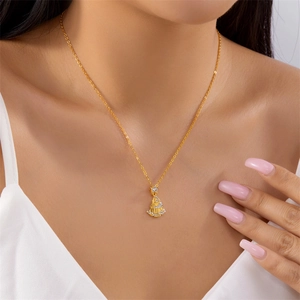 Close-up of gold Christmas tree necklace with sparkling rhinestones on female neck