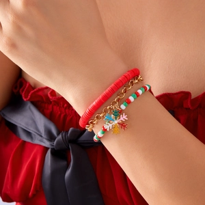 Macro shot of a Christmas 3-piece bracelet set with Santa and snowflake charms