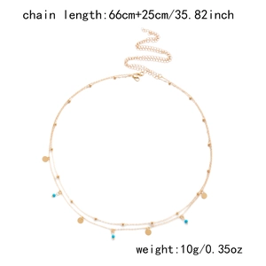 Detail of layered gold waist chain with blue beads and sequins measuring 66cm plus 25cm