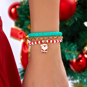 Detailed shot of Christmas clay bead bracelets with a Santa Claus charm on a wrist