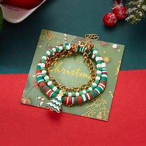 Close-up of Christmas polymer clay bracelet set with enamel tree charm and beads
