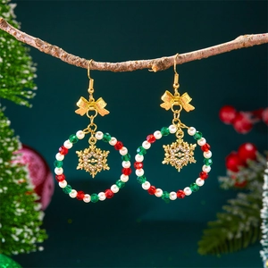 Christmas beaded hoop earrings with a gold snowflake pendant on a festive pine branch