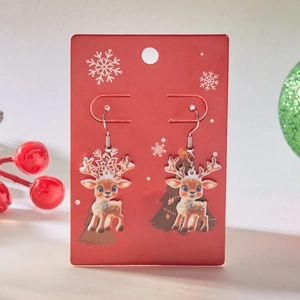 Cute acrylic reindeer earrings on festive red card for Christmas holiday accessory