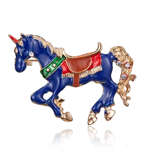 Detailed view of an alloy unicorn brooch with navy enamel and crystal accents on white