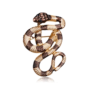 Detailed close-up of a serpentine alloy brooch with gold and brown enamel scale texture