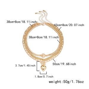 Detail view of multi-layer gold necklace with heart pendant and OT clasp dimensions