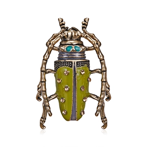 Detail of vintage beetle brooch with green enamel wings and sparkling rhinestones