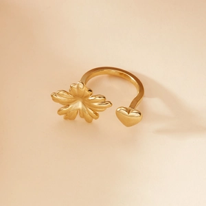 Detailed close-up of a gold adjustable open ring featuring a 3D flower and heart design