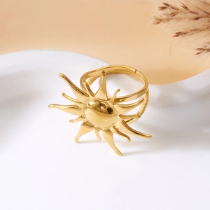 Close-up of golden sun-shaped adjustable ring with multi-layer band and metallic shine