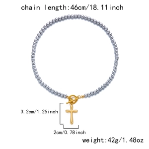 Detail view of natural stone beaded necklace with gold cross pendant and OT buckle specs