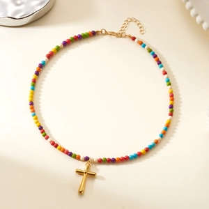 Detail of colorful stone beads necklace with a gold-tone cross pendant and adjustable clasp
