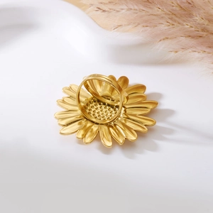 Detailed view of adjustable golden sunflower ring with matte finish petals on white base