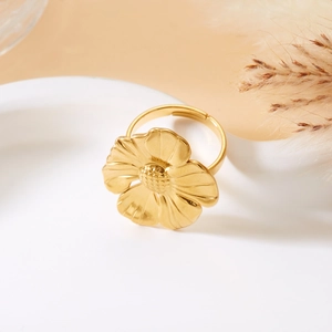 Macro detail of golden flower ring with textured petals and adjustable open band