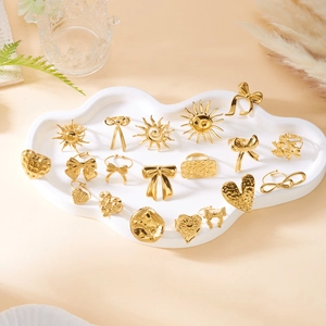 Golden stainless steel fashion ring set featuring butterfly heart and sun designs