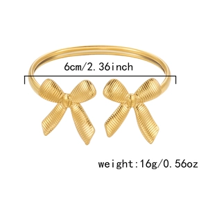 Detailed view of golden stainless steel bow cuff bracelet with 6cm diameter size labels