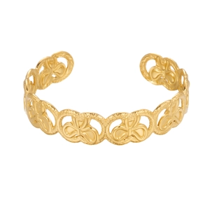 Close-up of gold cuff bracelet featuring hollow butterfly patterns and textured metal