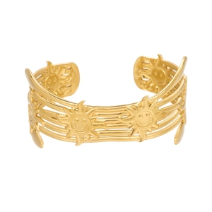 Macro view of gold layered cuff bracelet featuring sun smiley face engraved details