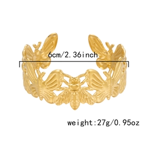 Detail view of gold butterfly open cuff bracelet showing 6cm diameter and 27g weight specs