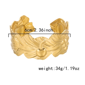 Detail of gold wide cuff bracelet with fruit carvings, showing 6cm inner diameter size