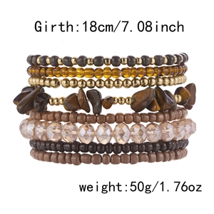 Detail view of Bohemian beaded bracelet set showing earth-tone stones and metallic beads