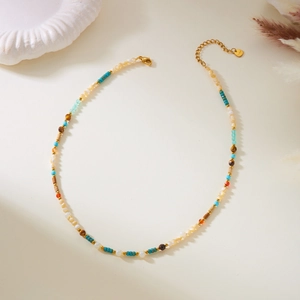 Close-up of bohemian beaded necklace with gold clasp and adjustable steel chain detail