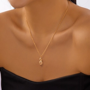 Detail of double teardrop crystal pendants on a gold chain necklace for women