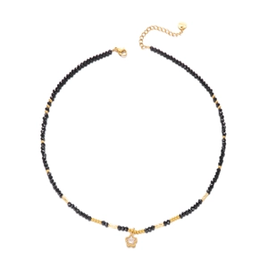 Detailed shot of bohemian beaded necklace with gold star pendant and S.Steel clasp tag