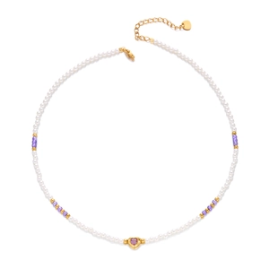 Detail of beaded necklace with purple heart pendant and golden extender chain