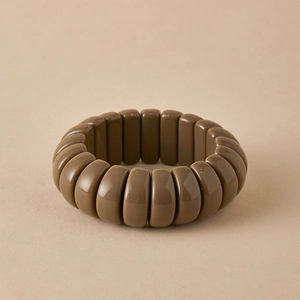 Close-up of olive brown beaded elastic bracelet with smooth glossy resin finish