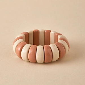 Close-up of terracotta and beige beaded elastic bracelet with high-gloss porcelain finish