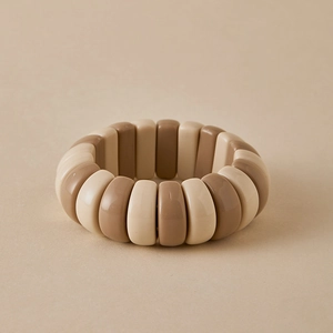 Macro shot of minimalist elastic bracelet with beige and khaki resin rectangular beads