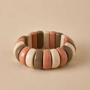 Close-up of elastic beaded bracelet with earthy rectangular resin beads in beige and brown