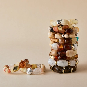 Handmade layered acrylic beaded bracelets with amber and marble texture in warm tones