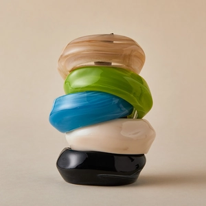 Stacked colorful acrylic bangles with marble texture in irregular geometric shapes