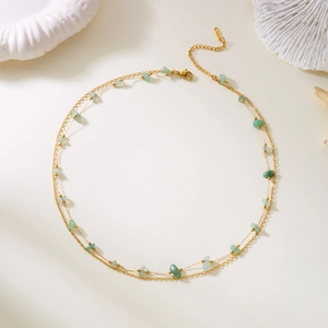Golden double-layer necklace featuring green natural stones and a minimalist design