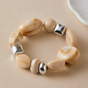Detail of beach style bracelet with brown resin beads and silver metallic accents