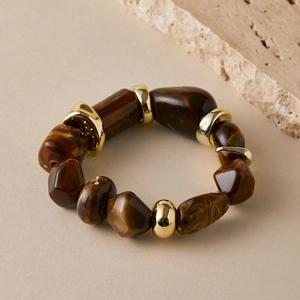 Detail of beaded bracelet with tortoiseshell resin beads and gold metal spacers