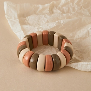 Detail of beaded elastic bracelet featuring Morandi tones of beige, brick red, and brown