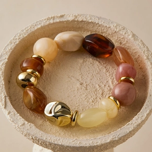 Bohemian style beaded bracelet with irregular earthy stones and gold metallic accents