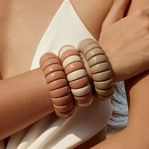 Three-color beaded elastic bracelets in brick red, cream, and brown for layered stacking